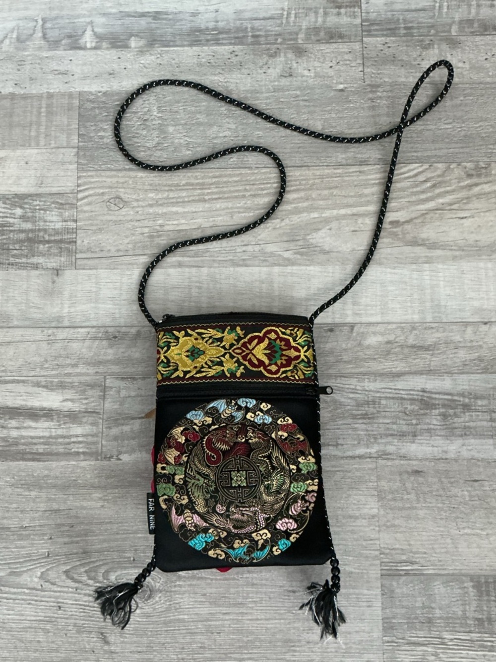 Far Nine black embroidered crossbody bag with a bohemian flair